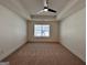 Carpeted bedroom featuring tray ceiling, ceiling fan and natural light at 1910 Victoria Way # 120, Conyers, GA 30013