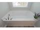 Luxurious soaking tub with stylish fixtures and a bright window view at 2851 Fareed St, Douglasville, GA 30135