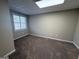 Unfurnished basement room featuring carpeting and natural light from the window at 6220 Grovener Ave, Douglasville, GA 30134