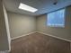 An unfurnished basement room with carpet and a window providing natural light at 6220 Grovener Ave, Douglasville, GA 30134