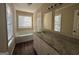 Bathroom featuring a bathtub, vanity, and ample natural light, creating a serene and functional space at 6220 Grovener Ave, Douglasville, GA 30134