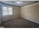 Inviting bedroom features plush carpeting, neutral walls, and a bright window, offering a comfortable and tranquil space at 6220 Grovener Ave, Douglasville, GA 30134