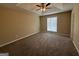 A spacious carpeted bedroom featuring a trey ceiling and a lighted ceiling fan at 6220 Grovener Ave, Douglasville, GA 30134