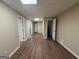 Hallway featuring wood plank floor, doors, and white trim at 6220 Grovener Ave, Douglasville, GA 30134