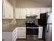 Well-equipped kitchen features modern appliances, ample granite countertops, white cabinets, offering both style and functionality at 6220 Grovener Ave, Douglasville, GA 30134