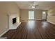 Bright living room features wood floors, a cozy fireplace, and a large window for natural light, enhancing the welcoming space at 6220 Grovener Ave, Douglasville, GA 30134