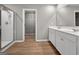 Bathroom boasts wood floors, double sink vanity, glass shower, and a walk-in closet at 301 Amsterdam Way, Hampton, GA 30228