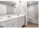 Well-lit bathroom featuring a double sink vanity and a shower-tub combo with a shower curtain at 301 Amsterdam Way, Hampton, GA 30228