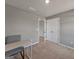 Bedroom with light grey walls, carpet, featuring a desk and chair at 301 Amsterdam Way, Hampton, GA 30228