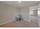 A bright room with a desk, chair and an open door leading into another room at 301 Amsterdam Way, Hampton, GA 30228