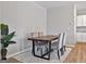 Dining room with a dark wood table, seating for six, neutral decor, and bright, natural light at 301 Amsterdam Way, Hampton, GA 30228