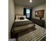 Cozy bedroom featuring a full bed with decorative pillows and a modern dresser with decor at 231 Ivey Ter # 47, Temple, GA 30179