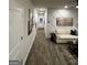Hallway featuring luxury vinyl plank flooring leading to the living room and entryway at 231 Ivey Ter # 47, Temple, GA 30179