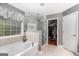Lovely bathroom featuring a soaking tub and a glass enclosed shower at 9800 Ivey Ridge Cir, Jonesboro, GA 30238