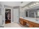 Bright bathroom with a double sink vanity and a walk-in closet at 9800 Ivey Ridge Cir, Jonesboro, GA 30238