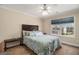 Warm bedroom features a queen bed and a window overlooking the backyard at 9800 Ivey Ridge Cir, Jonesboro, GA 30238