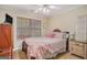 Comfortable bedroom featuring a ceiling fan and a bright window at 9800 Ivey Ridge Cir, Jonesboro, GA 30238