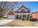 Charming two-story brick home with a well-manicured front yard and attached two-car garage in a quiet neighborhood at 9800 Ivey Ridge Cir, Jonesboro, GA 30238