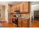 Well-equipped kitchen featuring wooden cabinets, granite countertops, and stainless steel appliances at 9800 Ivey Ridge Cir, Jonesboro, GA 30238