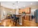 Bright kitchen with a breakfast bar, wooden cabinets, stainless appliances, and an adjacent dining area at 9800 Ivey Ridge Cir, Jonesboro, GA 30238