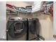 Convenient laundry room with modern washer and dryer units and ample shelving for storage at 9800 Ivey Ridge Cir, Jonesboro, GA 30238