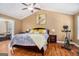 Comfortable main bedroom featuring a ceiling fan, and wood flooring at 9800 Ivey Ridge Cir, Jonesboro, GA 30238