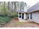 Back of the house with sunroom open to a patio and private, wooded backyard at 3821 Rex Mill Sq, Rex, GA 30273