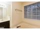 A relaxing bathroom showcasing a soaking tub and natural light from the window at 3821 Rex Mill Sq, Rex, GA 30273