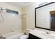 This clean bathroom features a shower/tub combo, toilet and vanity with a large mirror at 3821 Rex Mill Sq, Rex, GA 30273