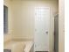 A spacious bathroom featuring a soaking tub, a window and a door at 3821 Rex Mill Sq, Rex, GA 30273