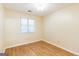 This bedroom has laminate flooring, a window, neutral walls, and ceiling lighting at 3821 Rex Mill Sq, Rex, GA 30273