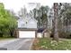 Charming two-story home featuring a brick and gray siding exterior and a two-car garage in a wooded neighborhood at 3821 Rex Mill Sq, Rex, GA 30273