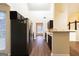 Open kitchen featuring stainless steel appliances, a breakfast bar, and dark wood cabinets with wood floors at 3821 Rex Mill Sq, Rex, GA 30273