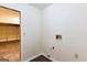 A utilitarian laundry room with a garage door and tile flooring at 3821 Rex Mill Sq, Rex, GA 30273