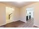 Living room with hardwood-style floors showcases staircase and kitchen view at 3821 Rex Mill Sq, Rex, GA 30273