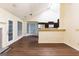 Bright and open living room with high ceilings, wood floors, fireplace, and a kitchen with stainless steel appliances at 3821 Rex Mill Sq, Rex, GA 30273
