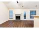 Inviting living room featuring a cozy fireplace and beautiful wood-look flooring at 3821 Rex Mill Sq, Rex, GA 30273