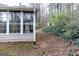 Exterior of sunroom, highlighting the multiple windows and adjacent yard at 3821 Rex Mill Sq, Rex, GA 30273
