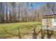 Expansive backyard bordered by mature trees, offering privacy and a serene setting at 440 Cottonpatch Rd, Lawrenceville, GA 30046