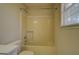 Bathroom featuring neutral walls, a toilet, shower and bathtub combination, and a window at 440 Cottonpatch Rd, Lawrenceville, GA 30046