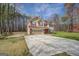 Charming two-story home with a tan exterior, a brick foundation, and a well-maintained lawn at 440 Cottonpatch Rd, Lawrenceville, GA 30046
