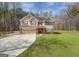 Charming two-story home with a tan exterior, a brick foundation, and a well-maintained lawn at 440 Cottonpatch Rd, Lawrenceville, GA 30046