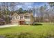 Charming two-story home with a tan exterior, a brick foundation, and a well-maintained lawn at 440 Cottonpatch Rd, Lawrenceville, GA 30046