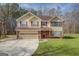 Charming two-story home with a tan exterior, a brick foundation, and a well-maintained lawn at 440 Cottonpatch Rd, Lawrenceville, GA 30046