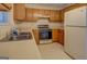 Functional kitchen layout featuring wood cabinetry, classic appliances, and ample counter space at 440 Cottonpatch Rd, Lawrenceville, GA 30046