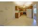 Bright kitchen showcasing wood cabinets, linoleum flooring, and a view to the backyard at 440 Cottonpatch Rd, Lawrenceville, GA 30046