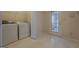 Convenient laundry room with white appliances, storage, and a door leading to the exterior at 440 Cottonpatch Rd, Lawrenceville, GA 30046