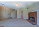 Spacious living room featuring a brick fireplace, stairs, neutral carpet, and an open floor plan at 440 Cottonpatch Rd, Lawrenceville, GA 30046