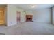 Spacious living room with carpet, a brick fireplace, neutral walls, and a glimpse into the dining room at 440 Cottonpatch Rd, Lawrenceville, GA 30046