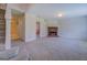 Spacious living room with carpet, a brick fireplace, neutral walls, and a glimpse into the dining room at 440 Cottonpatch Rd, Lawrenceville, GA 30046